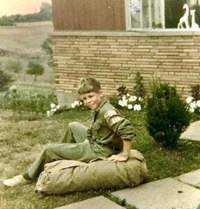 Doug sitting on law in Boy Scout uniform