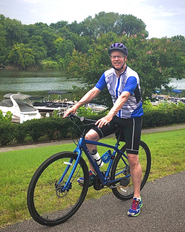 Doug on bike by water