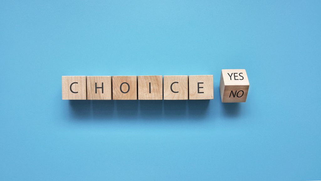 Choice spelled out in blocks. Last block teetering between Yes & No