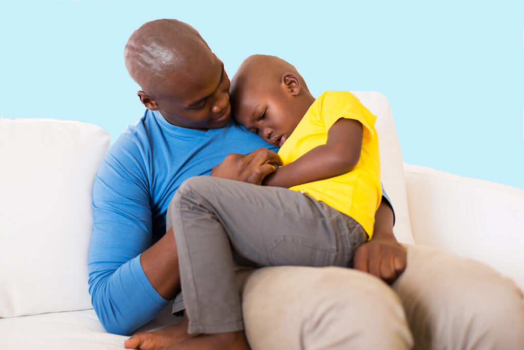 Father holding and supporting 5 year old son