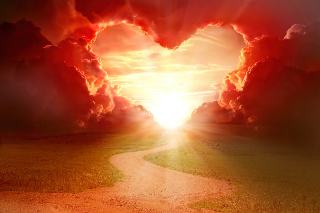 Clouds forming a heart with a sun shining through. Has a sentence on it: Thrive and Awaken® is an educational website for people interested in Self-Discovery and Conscious Awakening.