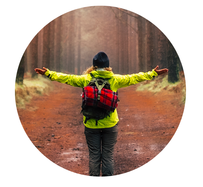 Person w outstretched arms to a forest