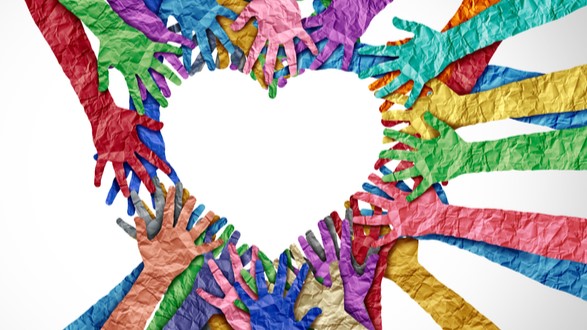 Hands made from colored paper coming together to form a heart